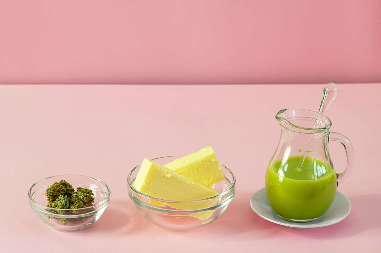 Making Cannabutter for Baking Edibles with Butter and Cannabis or Hemp on Pink Background with Copy Space